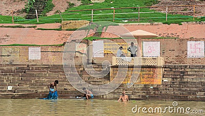 Indian Men Bathing On The Ganges River In Varanasi, India Editorial