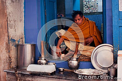 Indian milkman prepares the popular drink Lassi in fast-food store of historical city Editorial Stock Photo