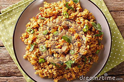 Indian minced chicken Bhuna Keema roasted with spices, tomatoes, chili peppers and onions close-up on a plate. Horizontal top view Stock Photo