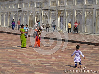 Gagra, India, November 21, 2013. Indian mothers in sari with children and other people near the walls of the Taj Mahal Editorial Stock Photo