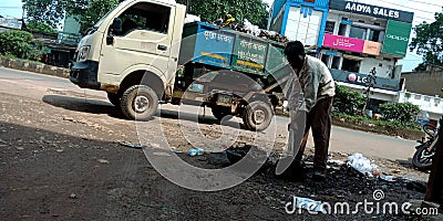 Indian munciple corporation worker collecting dirty mud from sewage on road side in india oct 2019 Editorial Stock Photo