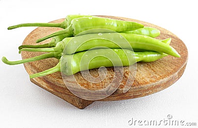 Indian Organic Long Green Chiles on a Wooden Table Stock Photo