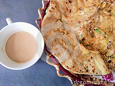 Indian Pakistani breakfast aloo wala paratha with tea Stock Photo