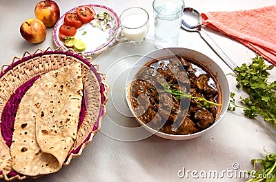 Indian Pakistani food cooked meal chicken masala kaleji gravy with chapati with salad delicious food cooked meat Stock Photo