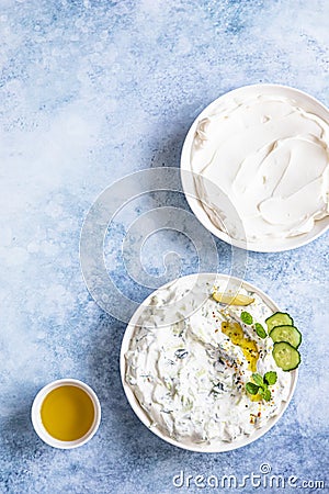 Indian or Pakistani raita sauce or dip with cucumber, yoghurt, garlic and mint, blue concrete background. Traditional Indian Stock Photo