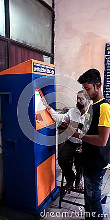 An indian passenger collecting tickets from automatic ticket vending machine counters Editorial Stock Photo