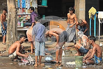 Indian people washing on the street Editorial Stock Photo