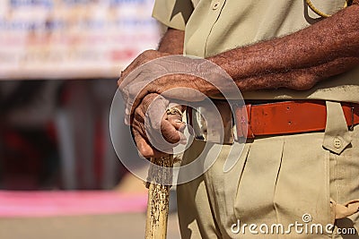 Indian policeman close to Police stick and uniform, Indian policeman & x28;CRPF& x29; with bamboo sticks patrols,hand in Stock Photo