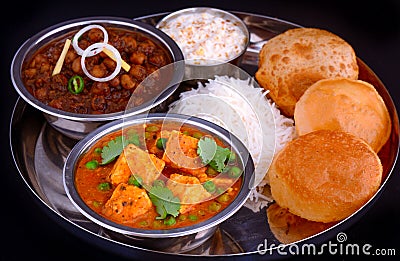 Indian Punjabi meal-curries served with rice and puri Stock Photo