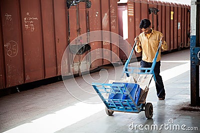 Indian railway worker pulling cart Editorial Stock Photo