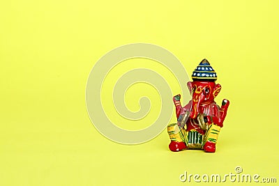 Hindu god Ganesh on yellow background. space for text Stock Photo