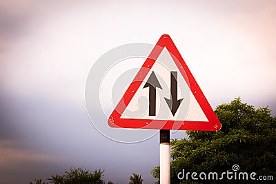 Indian road cautionary sign indicating changed pattern of traffic operation of the carriageway. Sign indicating traffic in one Stock Photo