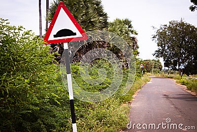 Indian road cautionary sign indicating speed breaker ahead. Sign indicating to slowdown as speed bump in road Stock Photo