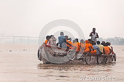 Indian rower man training his orange cloth rower men on the boat that floating over the Ganges Ganga river in Varanasi. Editorial Stock Photo