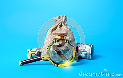 Indian rupee money bag and magnifying glass. Investigating capital origins. Anti money laundering, tax evasion. Deposit or loan Stock Photo