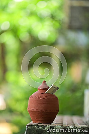 Indian rupees symbol and clay piggy bank Stock Photo