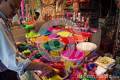 Indian Salesman in front of his shop selling colorful powder for Holi Festival, Jaipur, Rajasthan, India Editorial Stock Photo