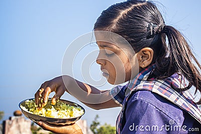 Indian school girl are eating food. Editorial Stock Photo