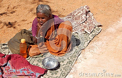 Indian senior blind woman seeks alms or begs on road to temple d Editorial Stock Photo