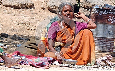Indian senior blind woman seeks alms or begs on road to temple d Editorial Stock Photo