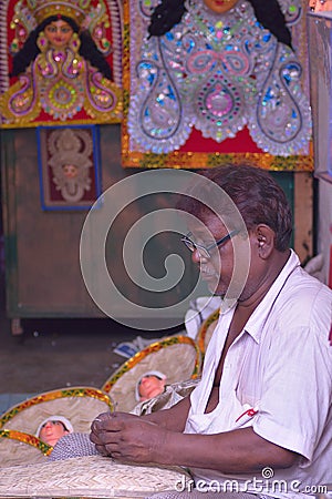 Indian small shop owner selling Idols & items for religious offering in Kolkata, India Editorial Stock Photo