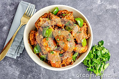 Indian Spiced Chicken Curry Garnished with Green Bell pepper and Cilantro Stock Photo