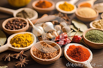 Indian spices and dried herbs on wooden table Stock Photo