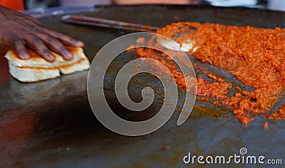 Indian street food vendor making pav baji or vada pav Stock Photo