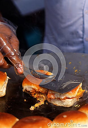 Indian street food vendor making pav baji or vada pav Stock Photo