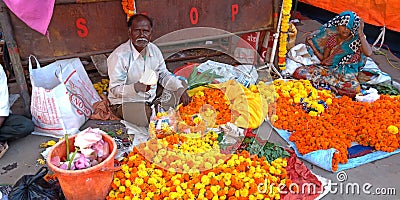 indian street marigolds flower shop for devotional purpose selling on road Editorial Stock Photo