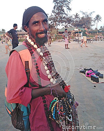 Indian street salesman in Arambol beach by the evening. Goa, India Editorial Stock Photo