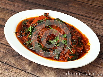 Indian style Bhindi masala or Okra curry also known as Ladyfinger, served over a rustic wooden table, selective focus Stock Photo