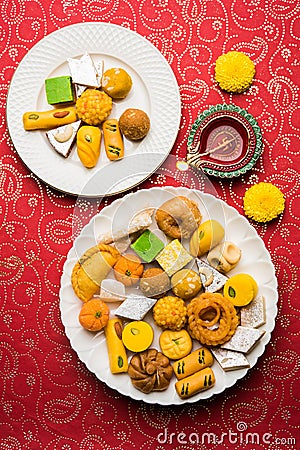 Indian sweets or Mithai for diwali festival with oil lamp or diya and gift box Stock Photo