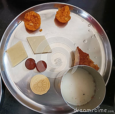 Indian sweets such as Ladoo, peda, gulab jamun, cashew barfi, Chennai poda etc. Served with butter milk Stock Photo