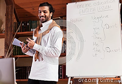 Indian Teacher Having English Class Online Talking To Laptop Indoors Stock Photo