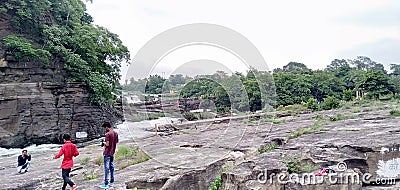 A Indian three friends take pictures in a waterfall. In Damodar River valley In Bhatinda waterfall Dhanbad Jharkhand Editorial Stock Photo