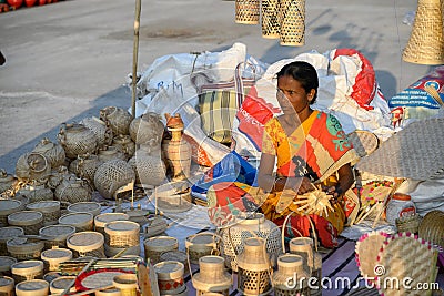 An Indian unidentified woman preparing bamboo carving artwork of bamboo sticks items for sale in Kolkata in handicrafts trade fair Editorial Stock Photo