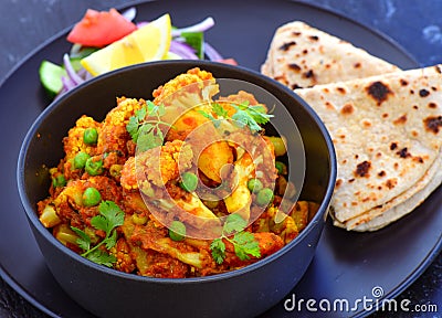 Indian vegetarian meal-Cauliflower Curry with roti Stock Photo