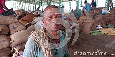 An indian village farmer smile during work at agriculture produce market Editorial Stock Photo