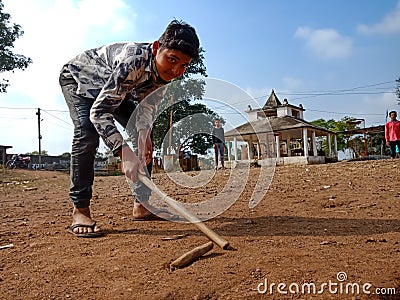 indian village kids playing Gilli danda at India January 1, 2020 Editorial Stock Photo