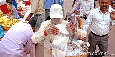 an indian village old man selling cotton for lamp during diwali festival Editorial Stock Photo