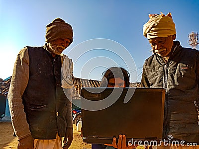 indian village people learning about laptop from school girl at open background in india January 2020 Editorial Stock Photo