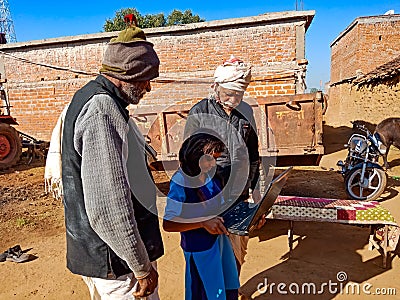 indian village people learning about laptop from school girl at open background in india January 2020 Editorial Stock Photo