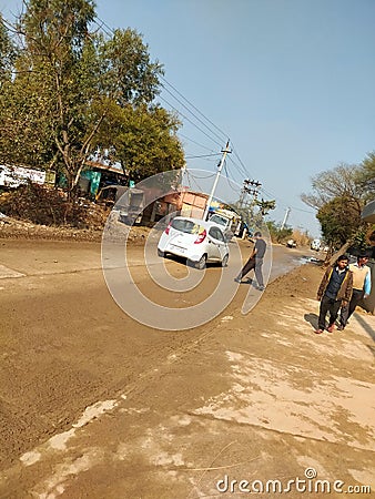 Indian village road with car and a green tree Editorial Stock Photo