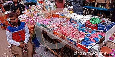 an indian village shopkeeper selling colors during diwali festival at indian market Editorial Stock Photo