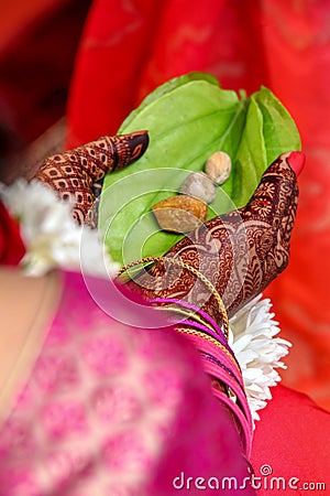 Indian wedding rituals leaf and supari in bride hand holding Stock Photo