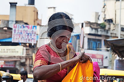 Indian woman chooses clothes at the Russell market in Bangalore Editorial Stock Photo