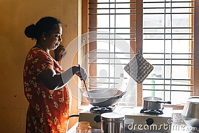 Indian woman cooking food in rural house Simple living Editorial Stock Photo