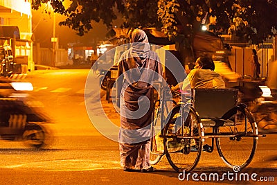 Indian woman with disabled man crossing the street Editorial Stock Photo