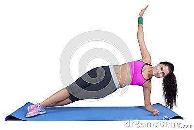 Indian woman doing side plank yoga pose Stock Photo